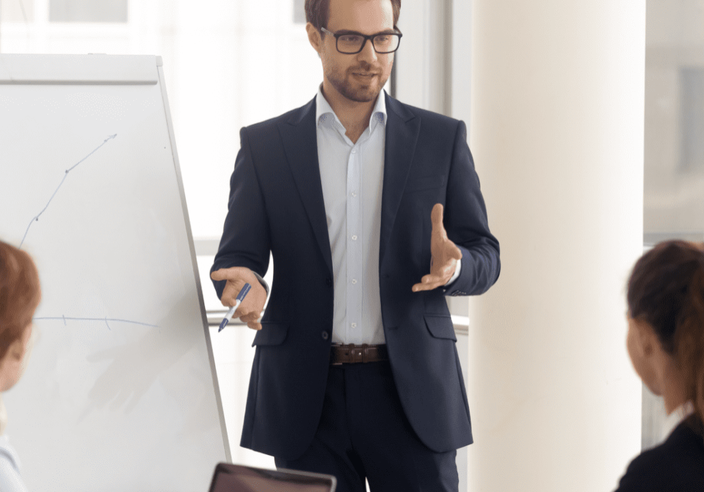 A man in glasses is giving a presentation